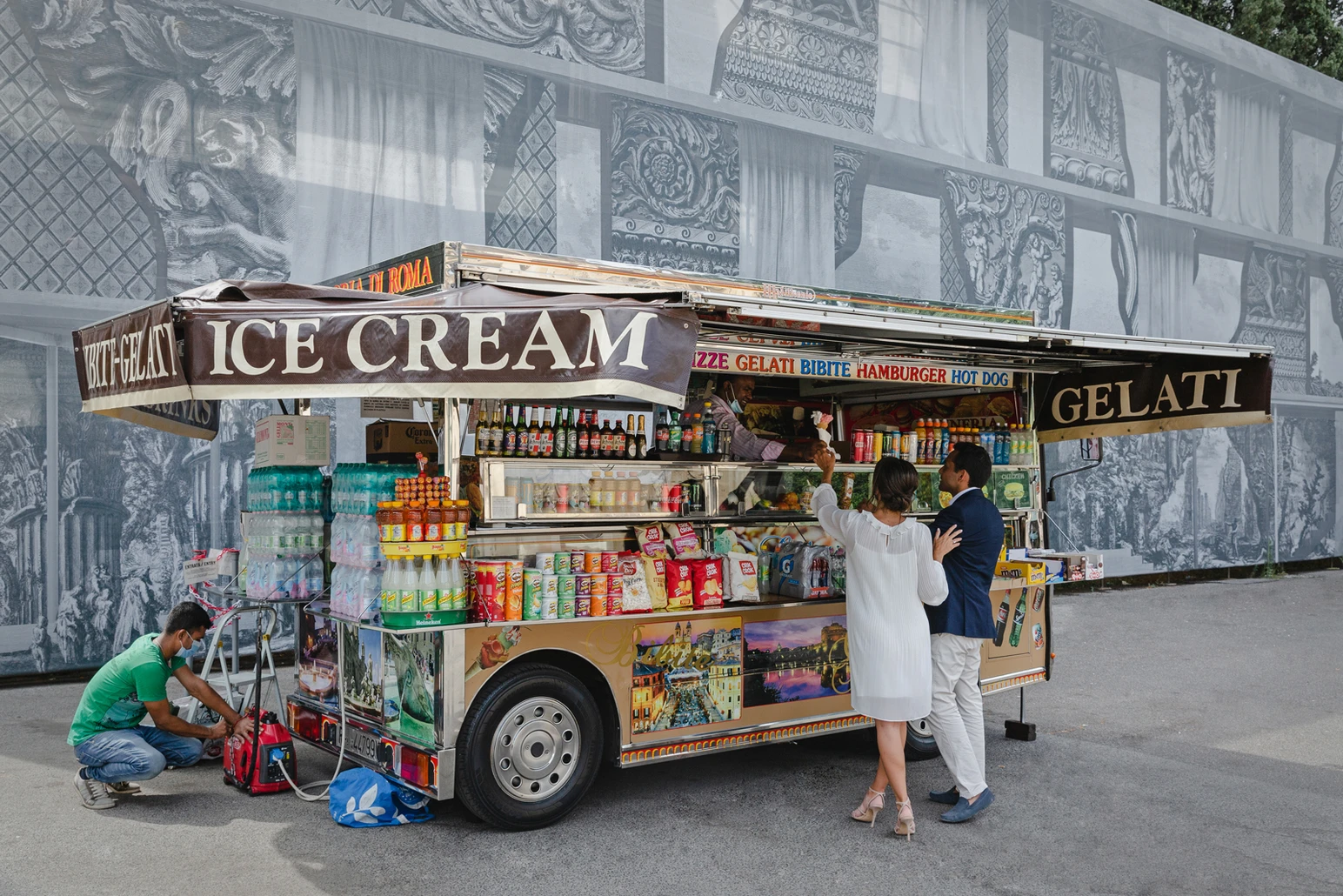 A couple ordering gelato from a street cart in Rome