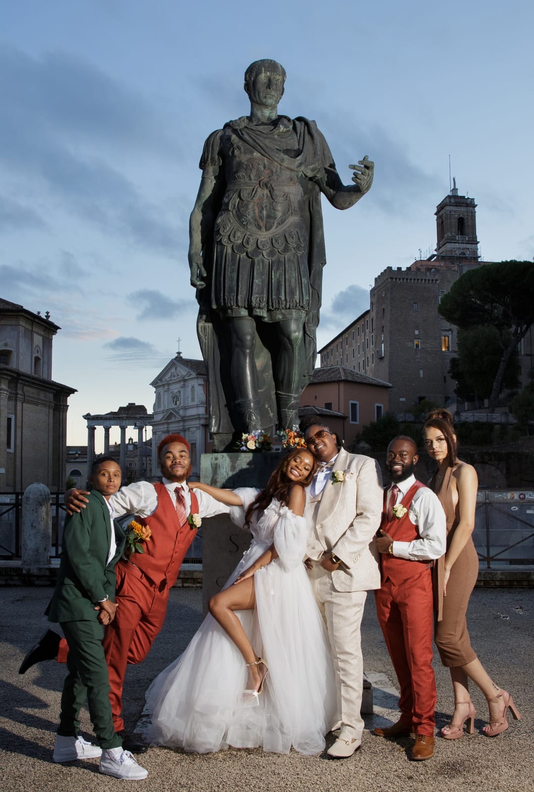 A wedding party gathered at Piazza del Campidoglio at dusk