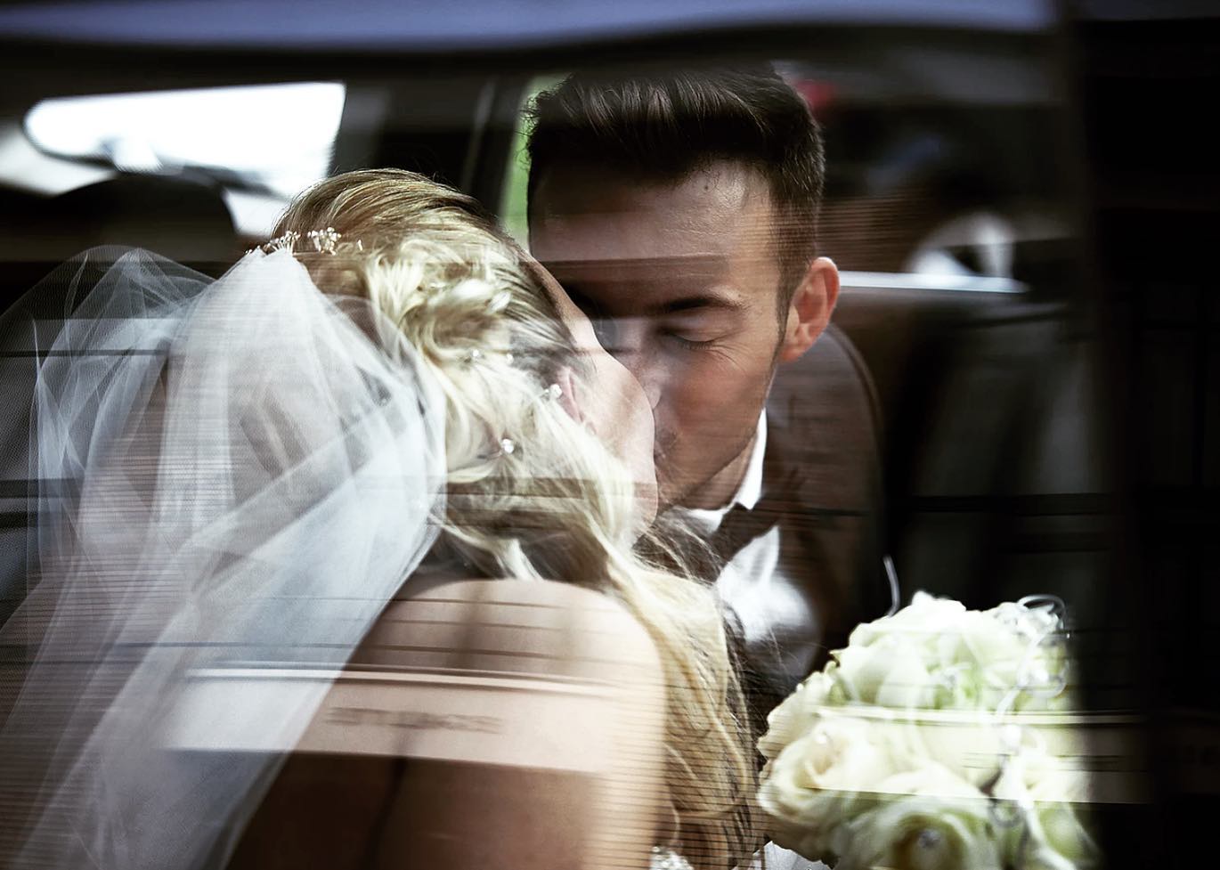 A couple reflected in a car window in Paris
