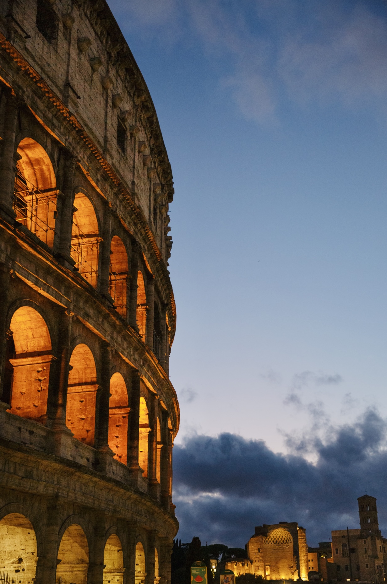 The Colosseum illuminated against the blue evening sky