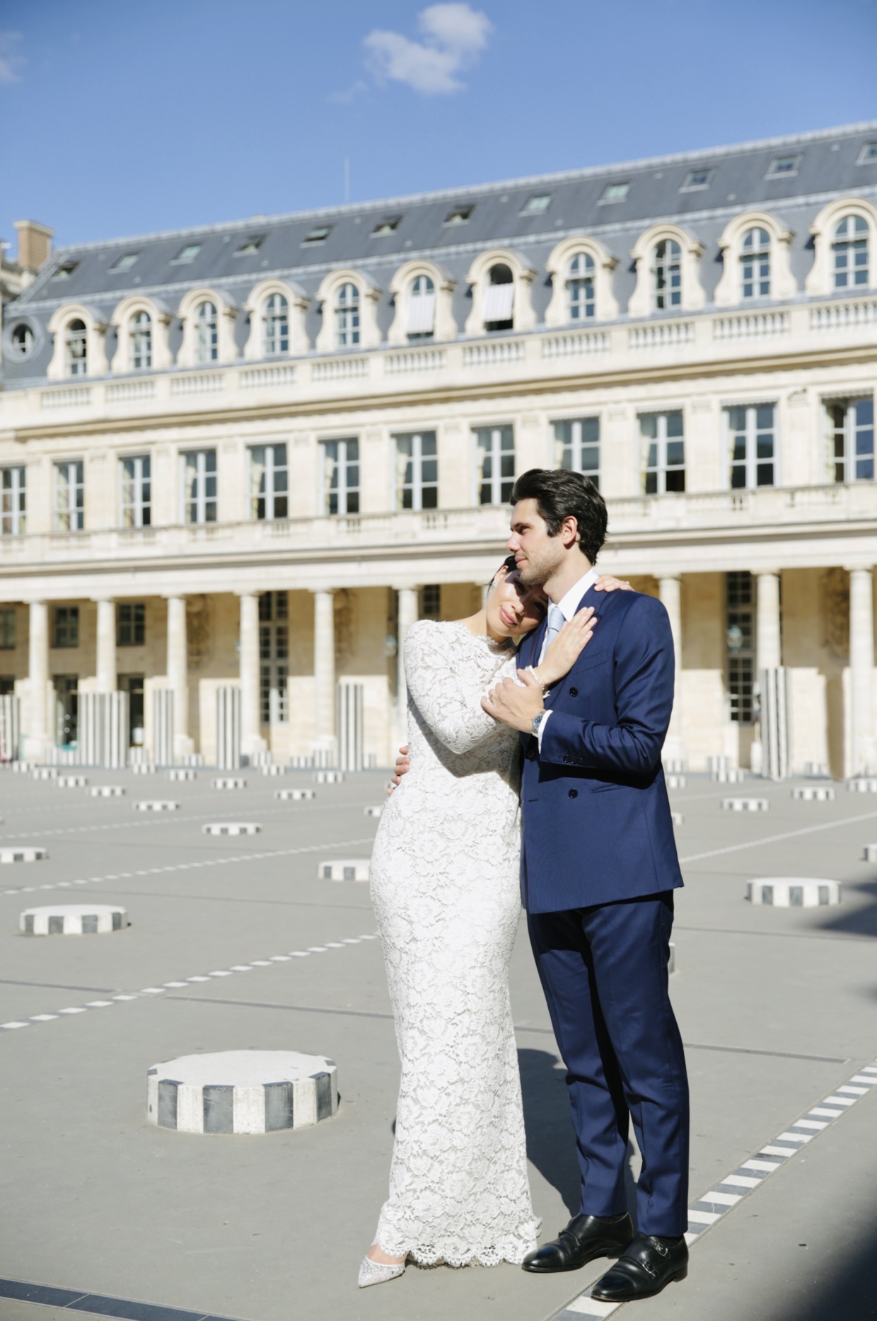 A bride and groom in a pale Parisian interior