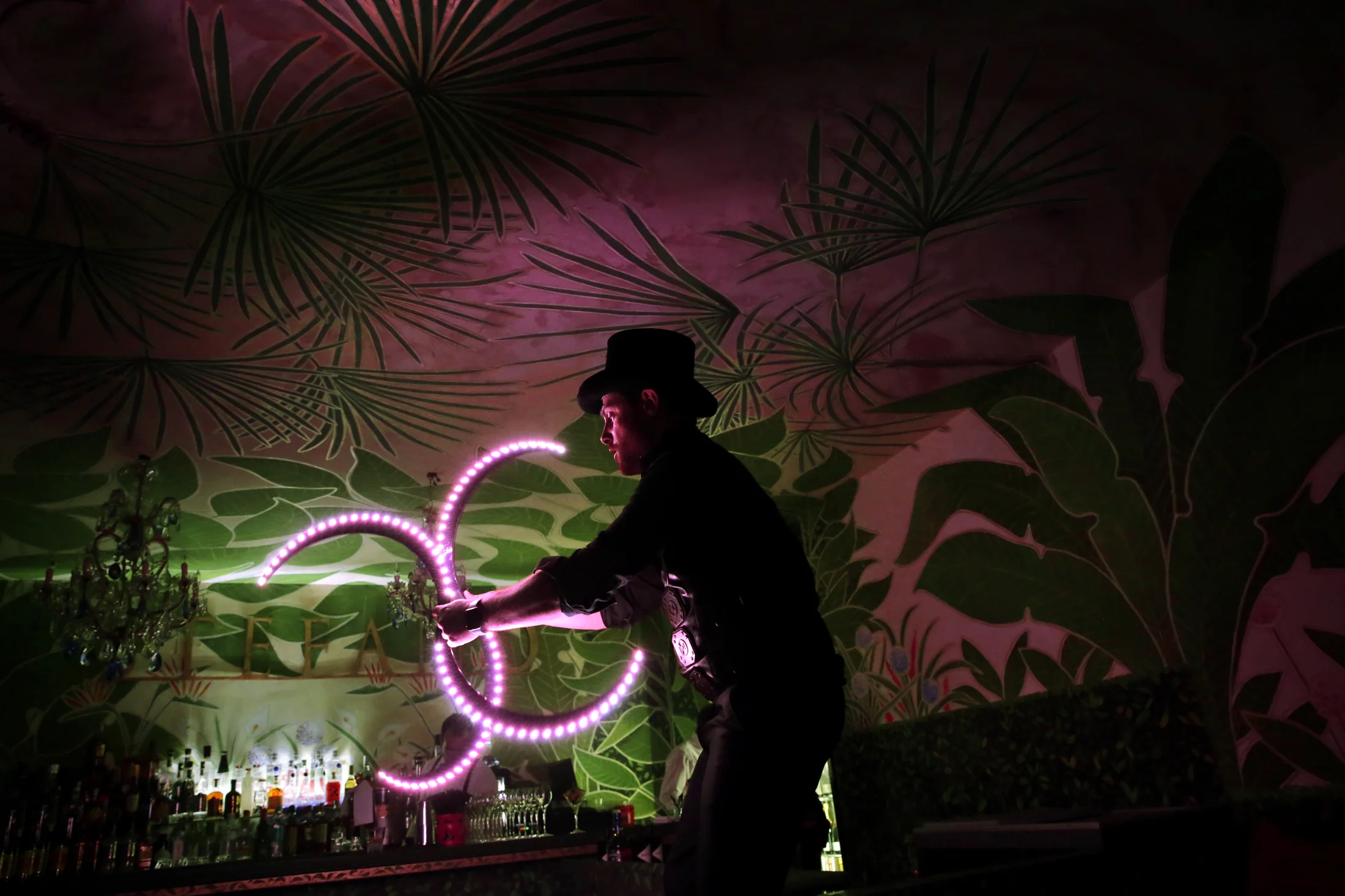 A dancer traced by coloured light at night