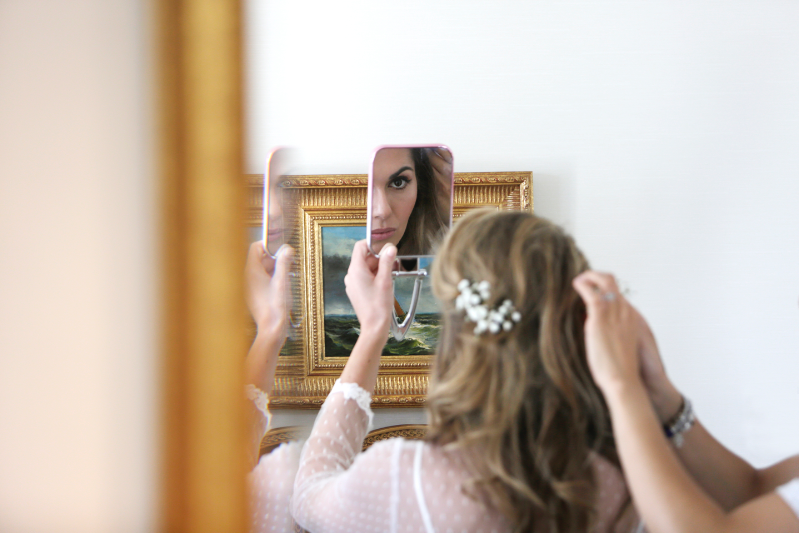 A bride checking her reflection in a compact mirror