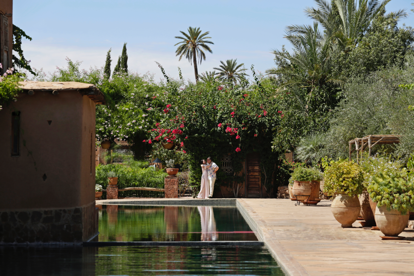 A bride seated in a warm, richly layered Marrakech interior