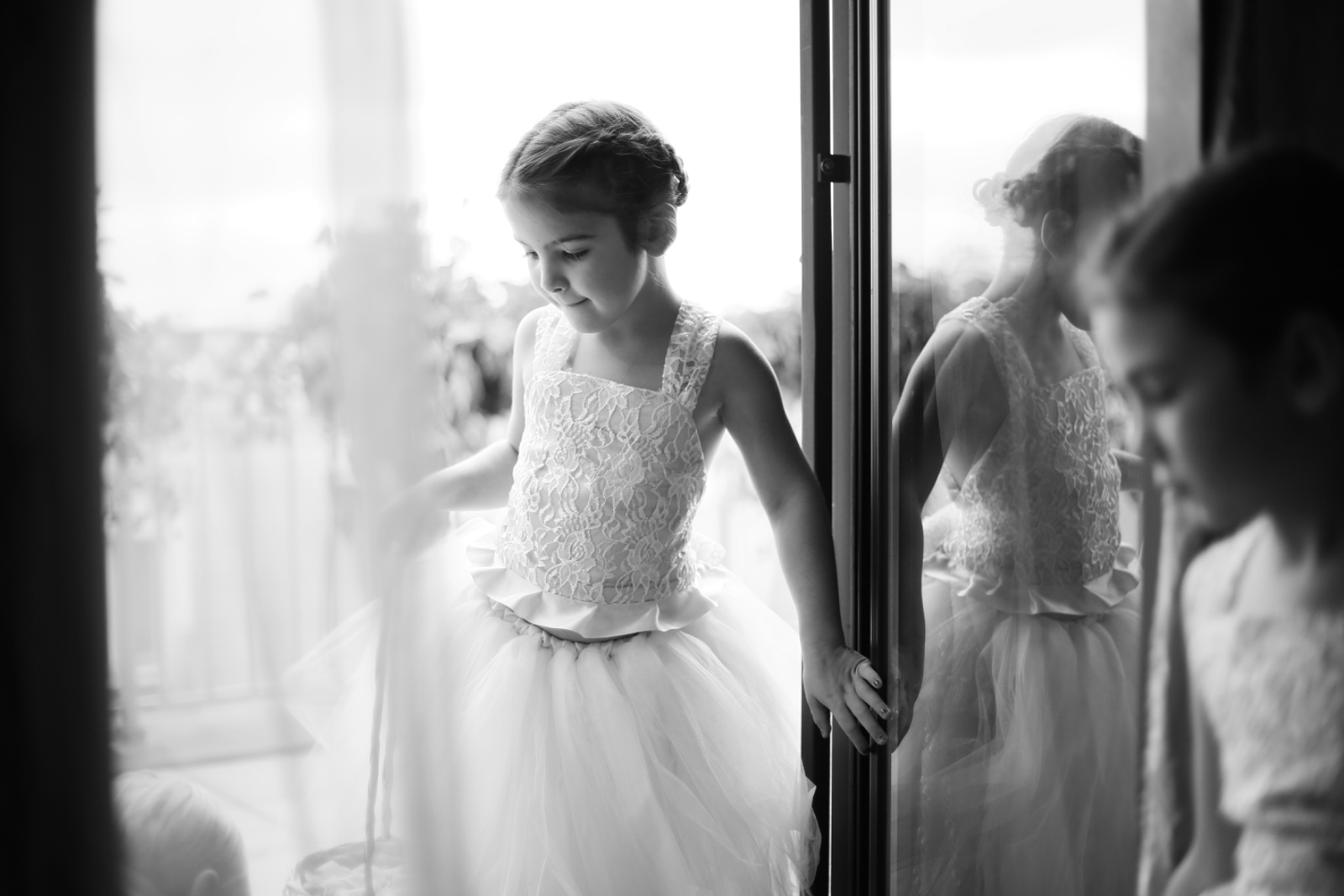 A bride on a Paris terrace with the Eiffel Tower held at the edge of the frame