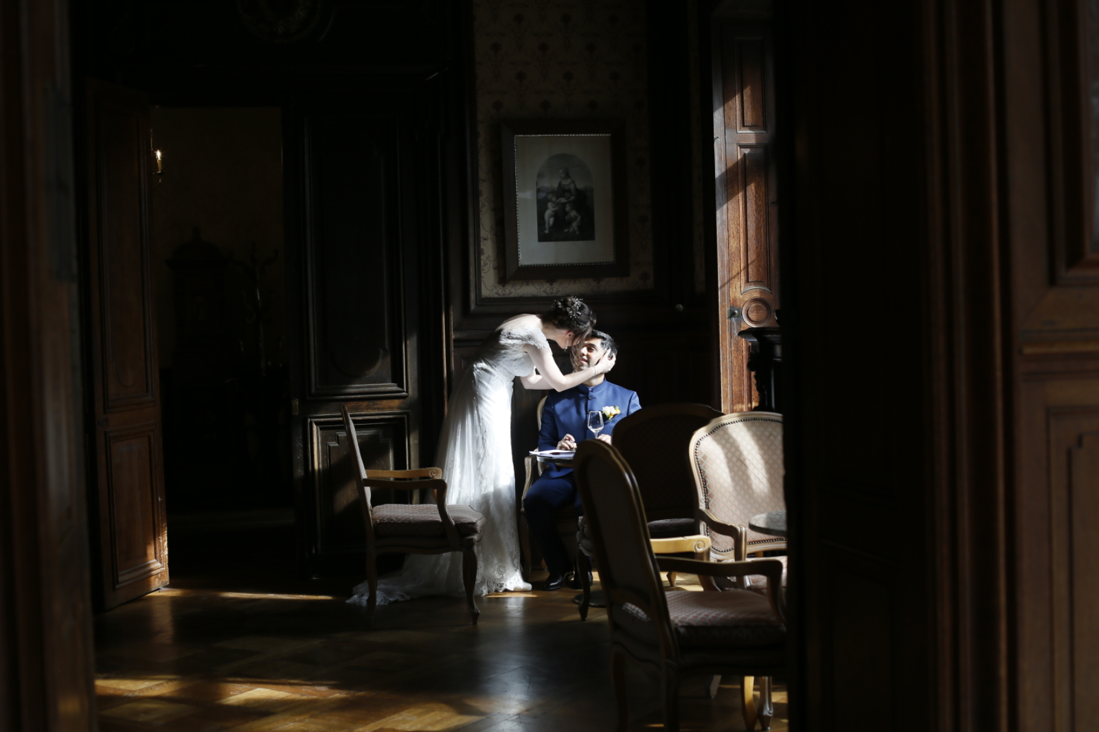 A bride seated beside a softly lit window