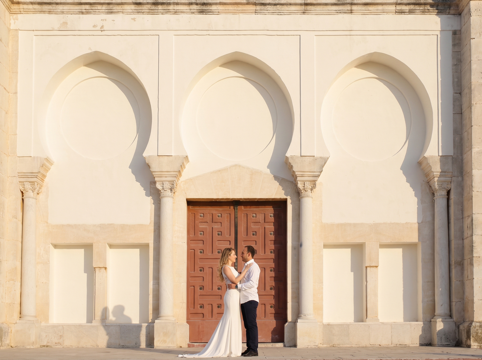 A bride crossing formal château grounds