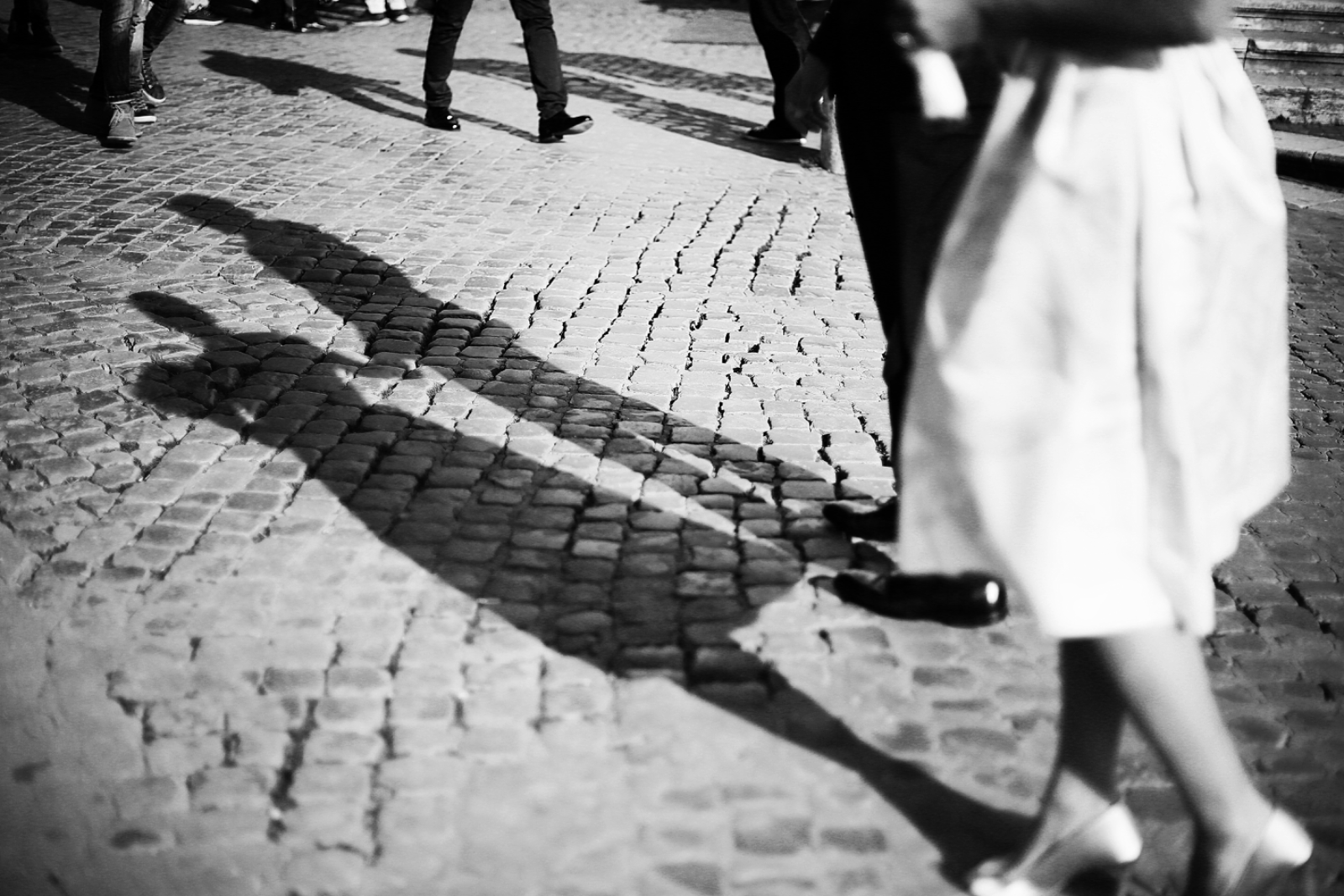 A wedding party crossing a Roman street beside the Colosseum